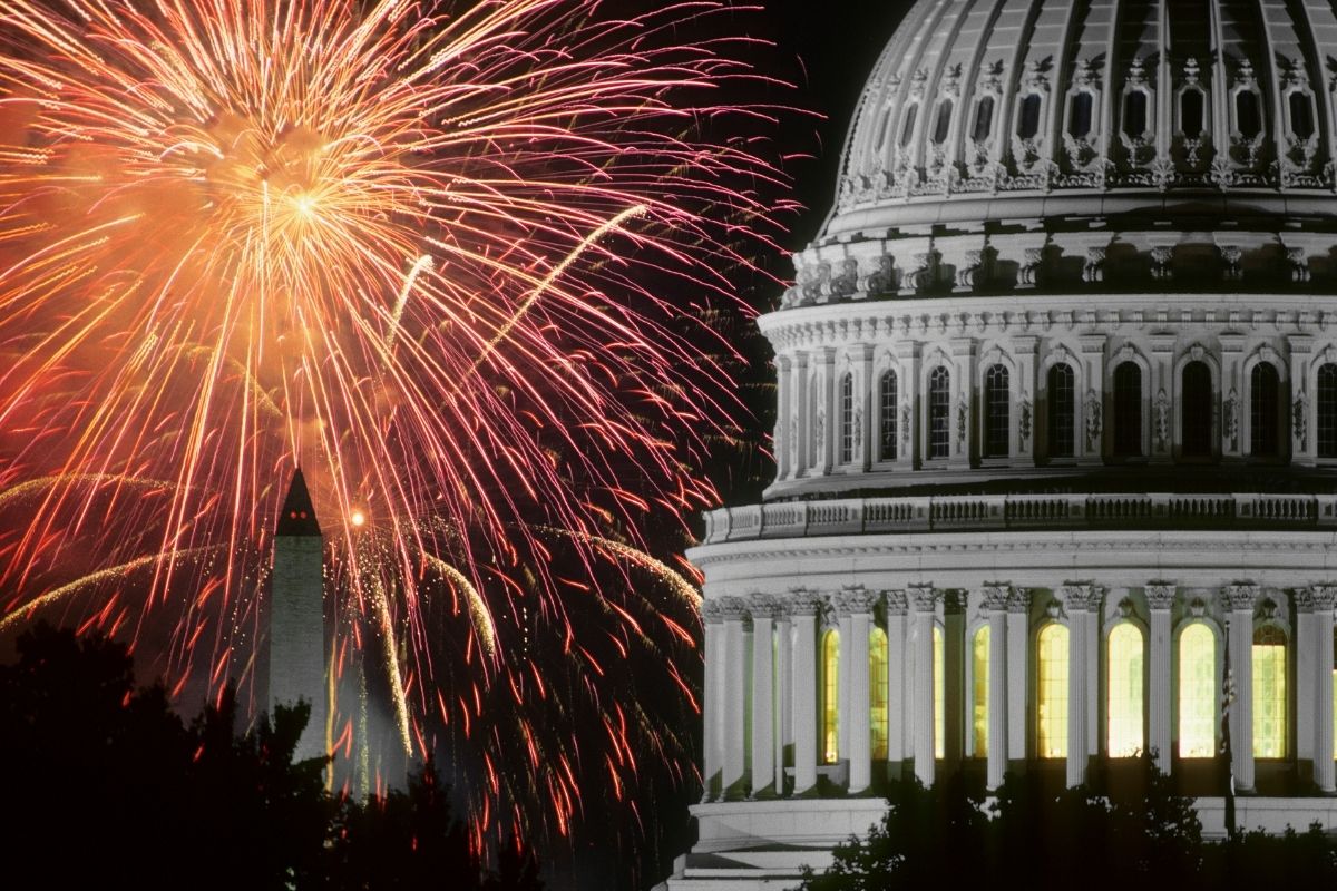 Fireworks explode behind the Washington Monument on the National Mall