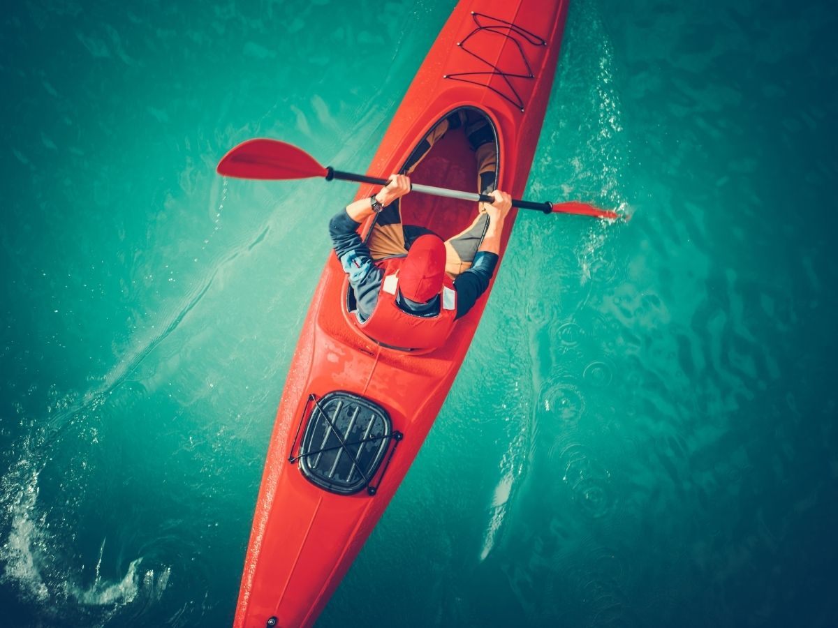 Man in red kayak in river