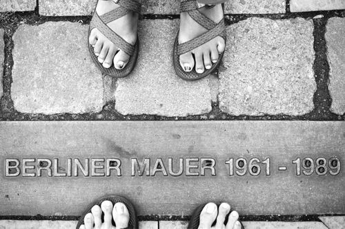 Feet on the line of the old Berlin Wall