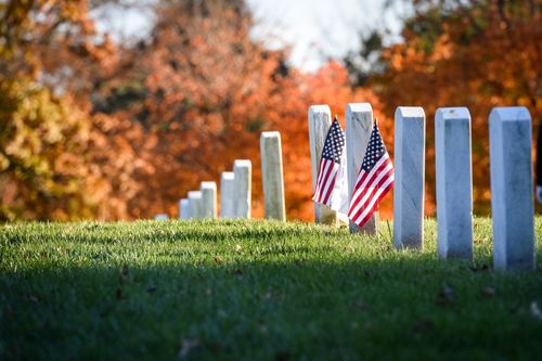 White Granite Gravestones with American Flags at Arlington National Cemetery